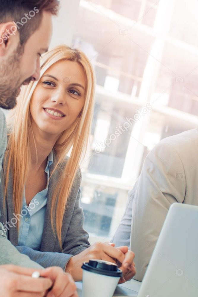 Happy smiling business team in office.Business team working together to achieve better results.